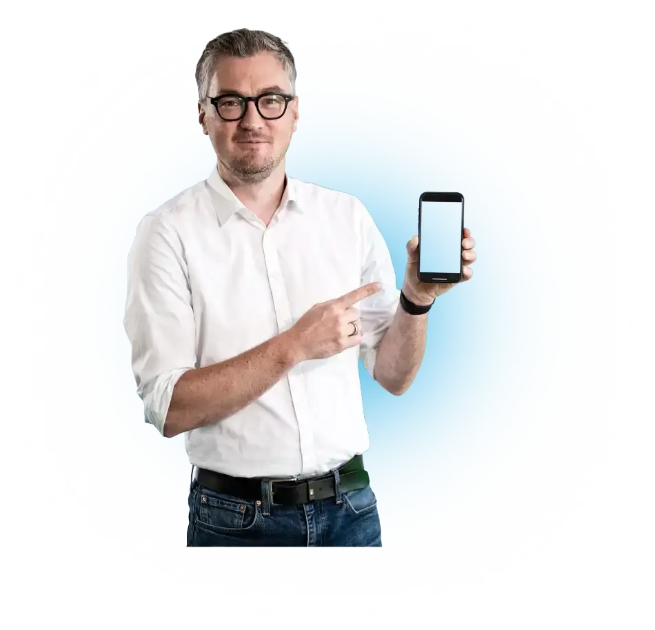 A man in a white shirt is pointing at a smartphone with a blank screen.