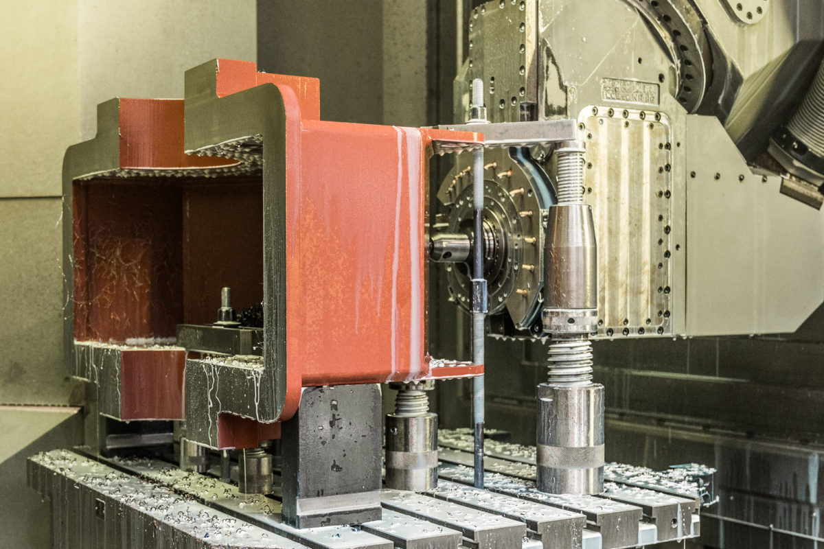 Metal block in a CNC milling machine during machining.