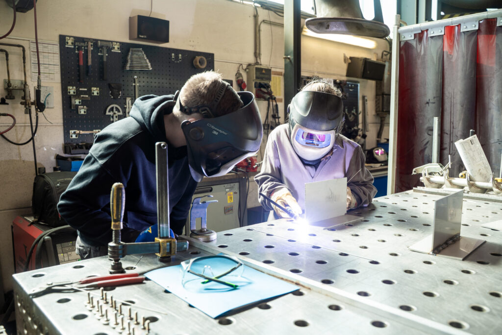 Spaleck Employee Teaches a Student How to Weld