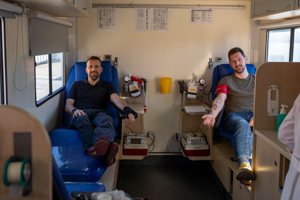 Two Spaleck employees donate blood at the German Red Cross (DRK) bloodmobile during Spaleck's Blood Donation Day